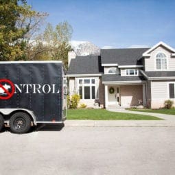 Pest control van in front of a house.