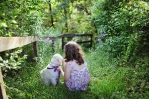 girl and dog in the nature