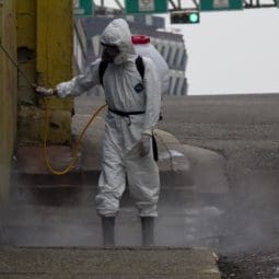 man spraying the wall