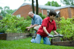 Boy and man working in the garden