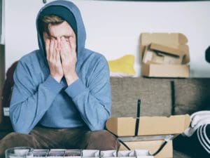 Man covering his face