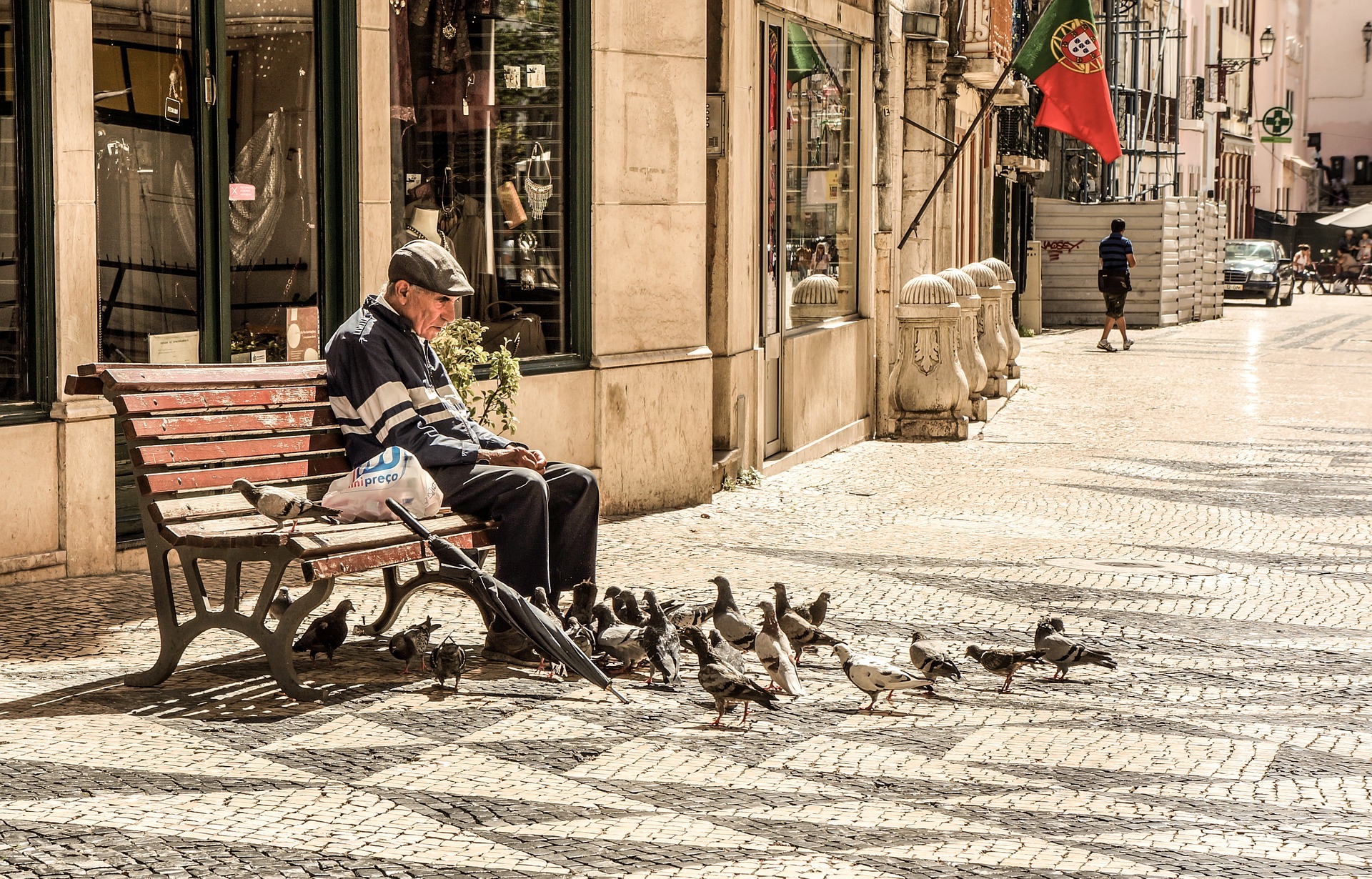 Senior surrounded by pigeons